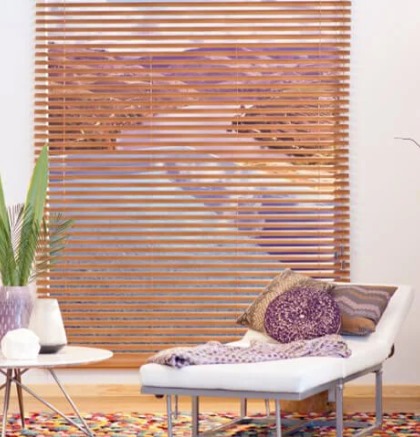 un cuarto con una silla y una mesa y persianas enrollables tipo madera